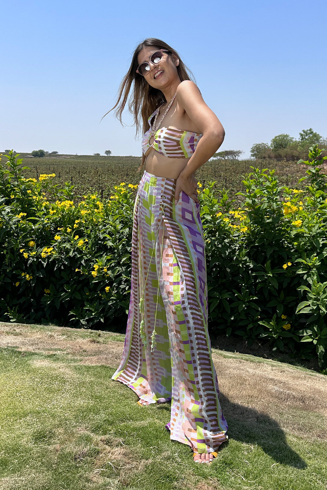 Deepika Ghose Geometric Printed Bralet with Hand Embroidered Straps and Center Ring detailing and Geometric Printed Flared Pants with Rivet Detailing from Magical Wilderness Collection