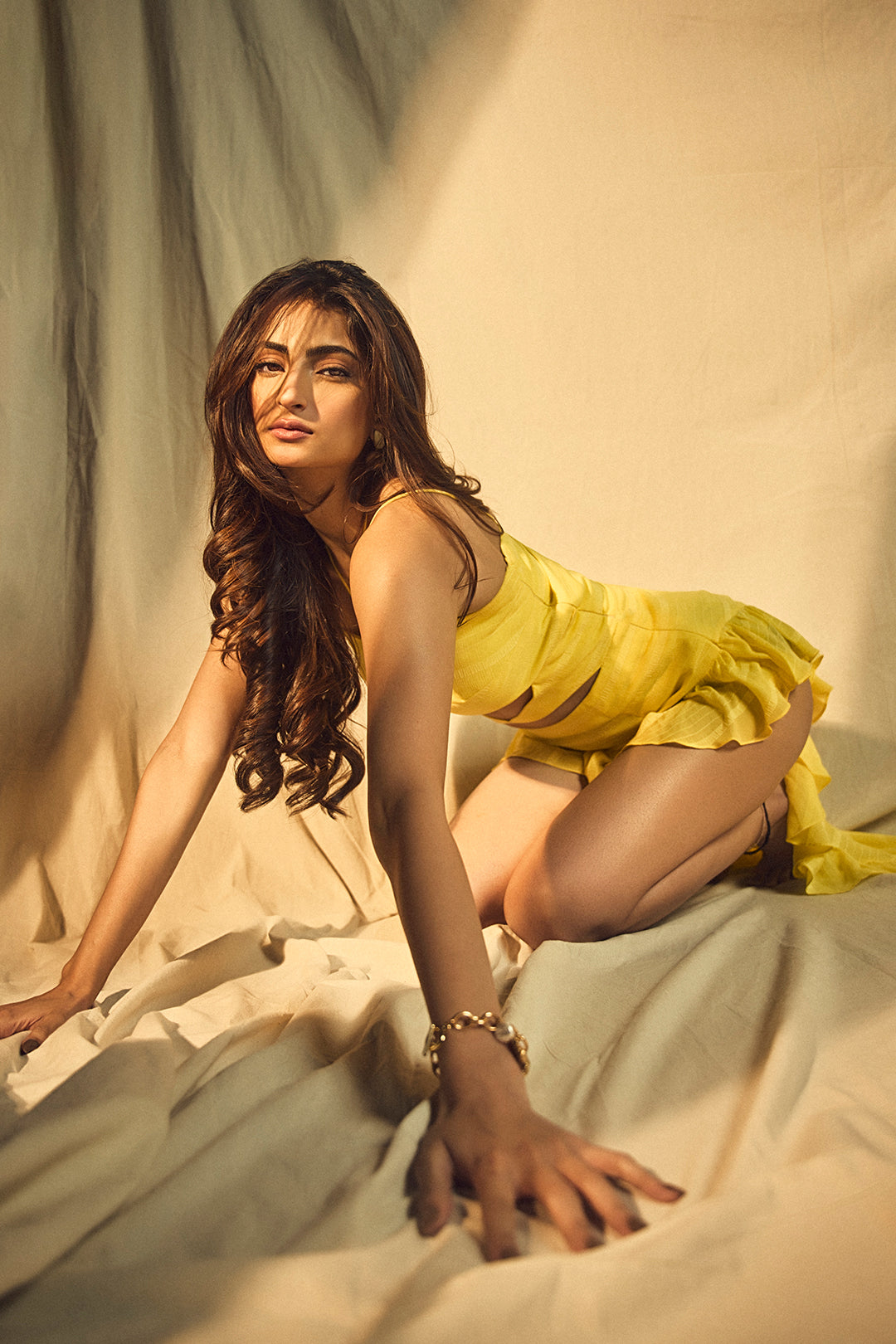 Palak Tiwar in Nirmooha's Lemon Yellow Cutout Asymmetrical Dress with attached Hand Embroidered Tassels from Magical Wilderness Collection