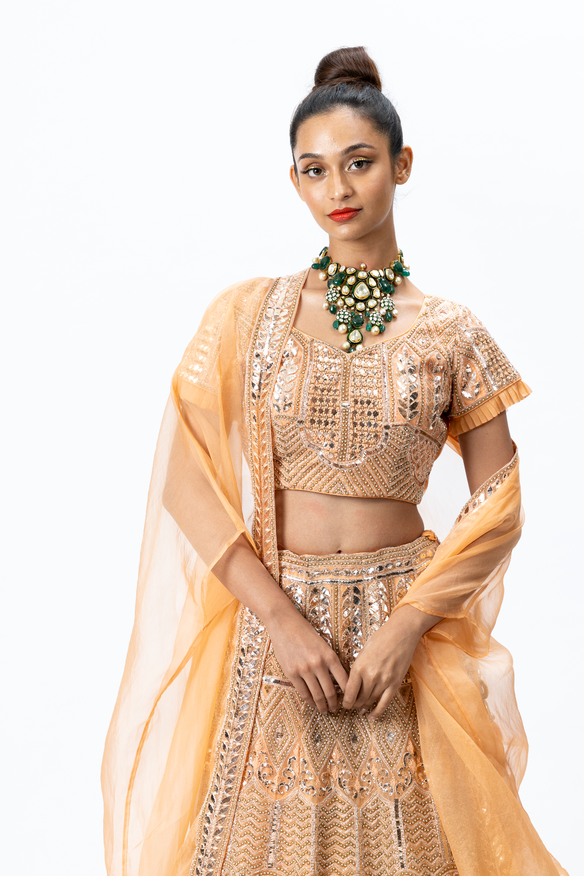 Orange Hand-embroidered Lehenga paired with Hand-embroidered Blouse and Cape with Hand-embroidered Border