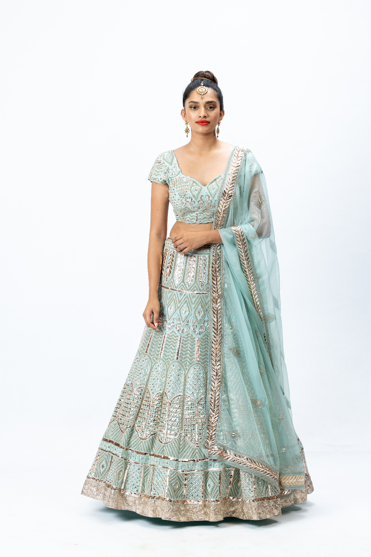 Powder Blue Hand-embroidered Lehenga paired with Hand-embroidered Blouse and Hand-embroidered Dupatta with buttis