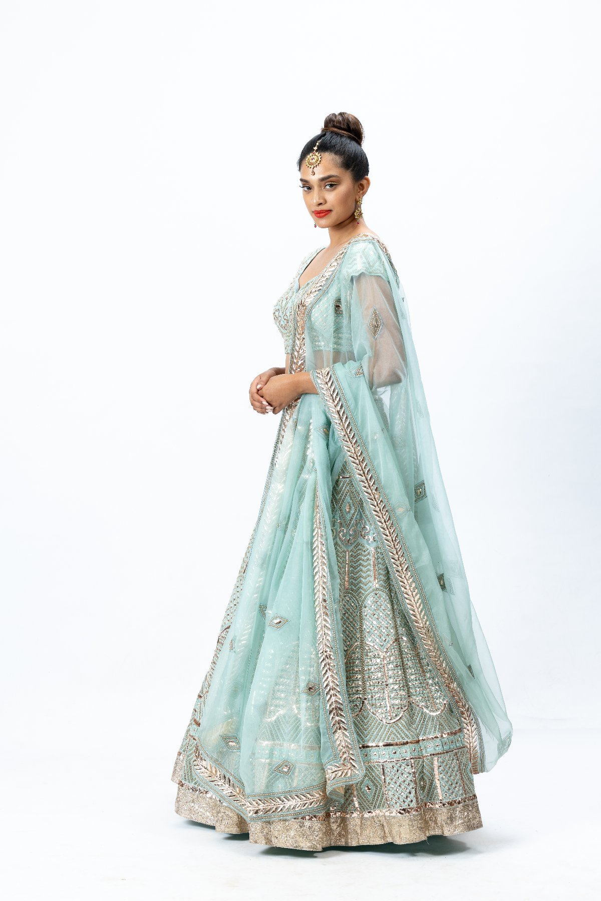 Powder Blue Hand-embroidered Lehenga paired with Hand-embroidered Blouse and Hand-embroidered Dupatta with buttis