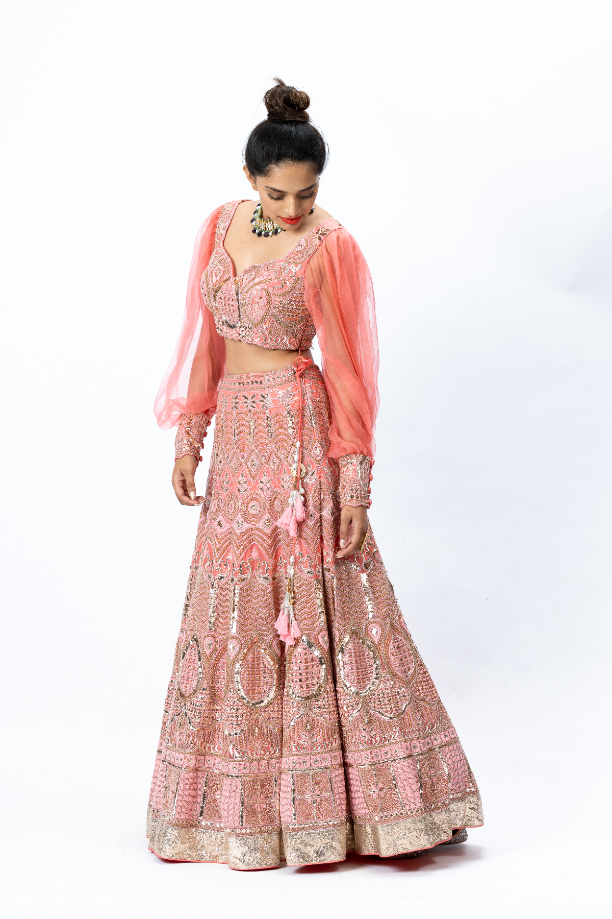 Coral Hand-embroidered Lehenga paired with Balloon-sleeved Hand-embroidered Blouse and Hand-embroidered Dupatta with buttis