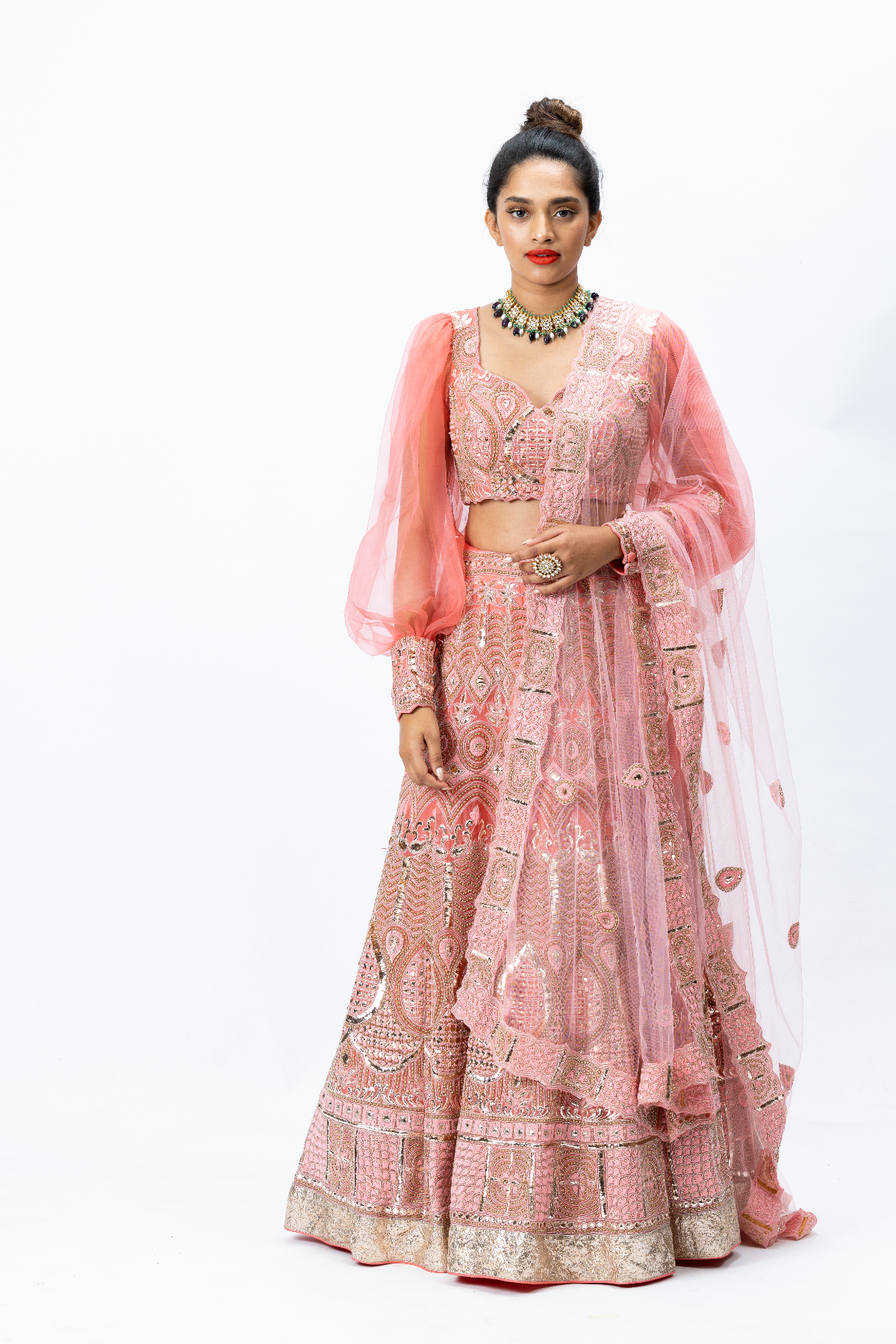 Coral Hand-embroidered Lehenga paired with Balloon-sleeved Hand-embroidered Blouse and Hand-embroidered Dupatta with buttis
