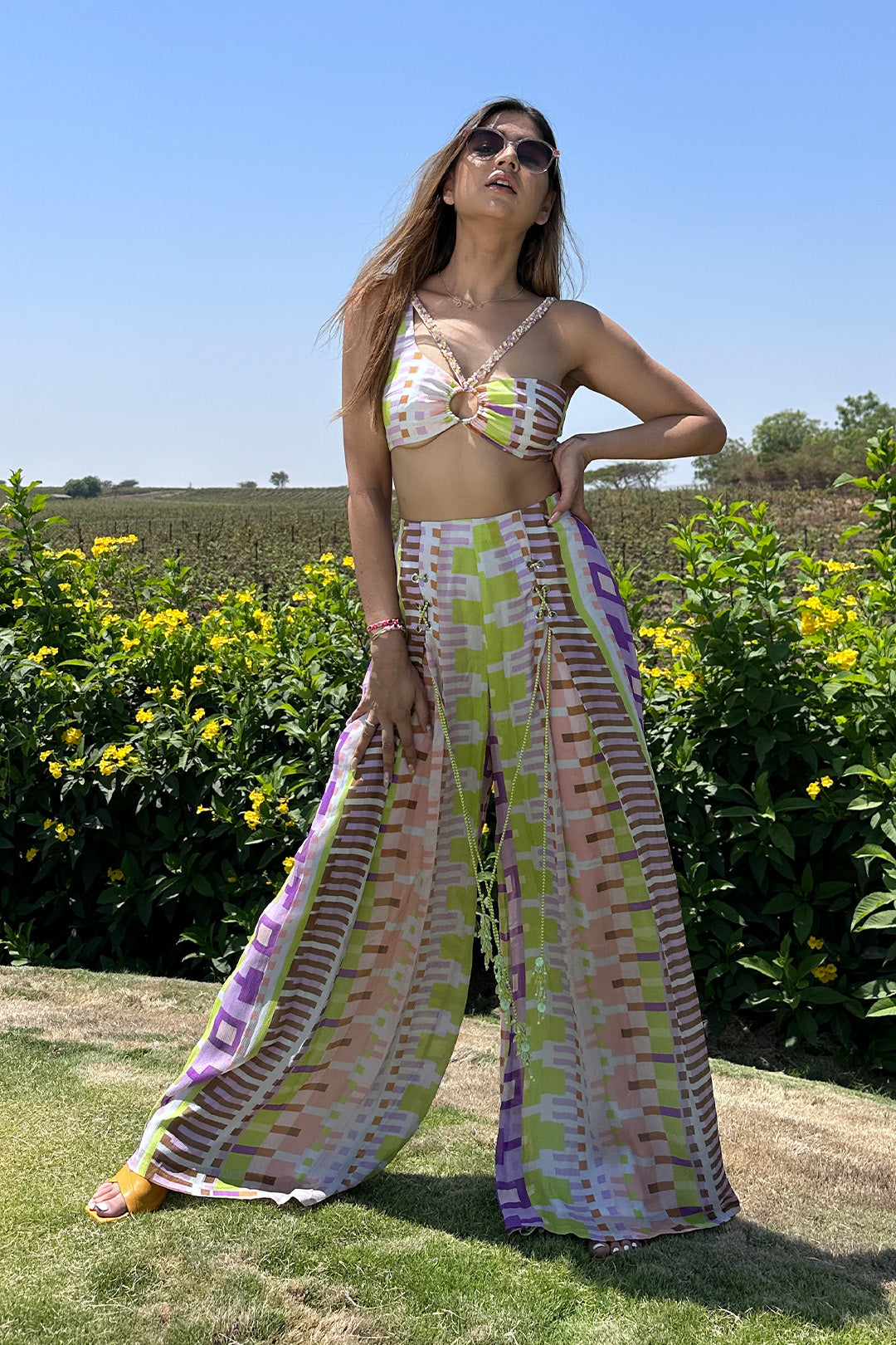 Deepika Ghose Geometric Printed Bralet with Hand Embroidered Straps and Center Ring detailing and Geometric Printed Flared Pants with Rivet Detailing from Magical Wilderness Collection