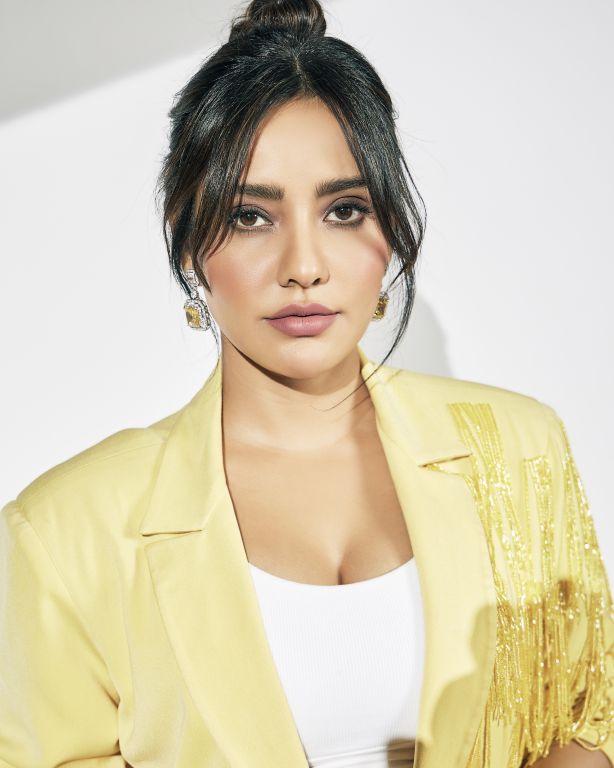Neha Sharma in in Nirmooha's Lemon Yellow Cording Bralet with Ring and attached Hand Embroidered Tassels Fringes,Lemon Yellow Oversized Blazer with Hand embroidered Tassels Fringes and Pants from Magical Wilderness Collection