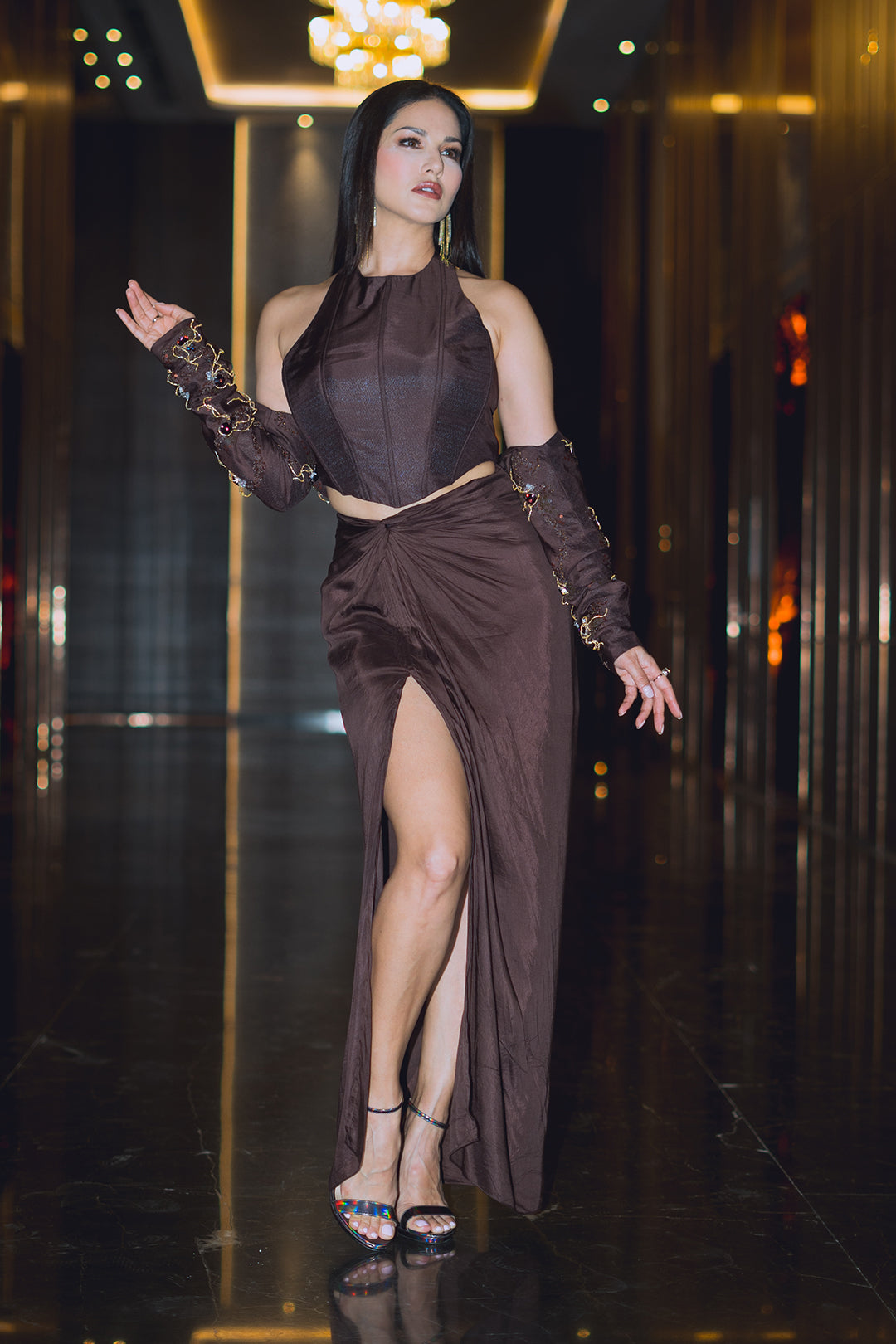 Sunny Leone in Nirmooha's Brown Corset Top with Hand Embroidered Bolero and Knotted Drape Skirt from Aham Asmi Collection.