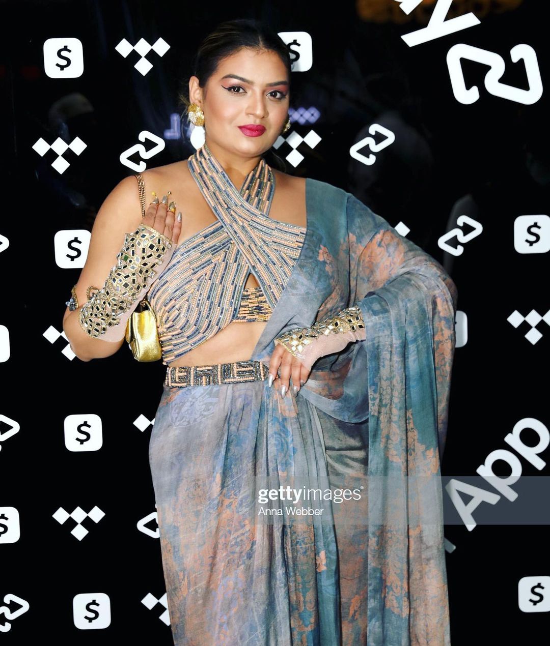 Rini Jain in Nirmooha's Halter Neck Hand-Embroidered Blouse with Cording detailing, Draped Chiffon Saree and Hand-Embroidered Belt  from Ancienne Collection