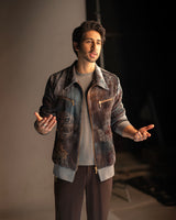 Vihaan Samant in Nirmooha's Printed Velvet Bomber Jacket with Grey T-Shirt and Brown Pants from Ancienne Collection