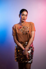 Regina Cassandra in Nirmooha's Crop T-Shirt with Sunflower Motif and Golden Sequin Short Skirt from the Ancienne Collection