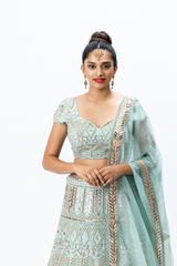Powder Blue Hand-embroidered Lehenga paired with Hand-embroidered Blouse and Hand-embroidered Dupatta with buttis