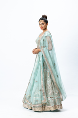 Powder Blue Hand-embroidered Lehenga paired with Hand-embroidered Blouse and Hand-embroidered Dupatta with buttis