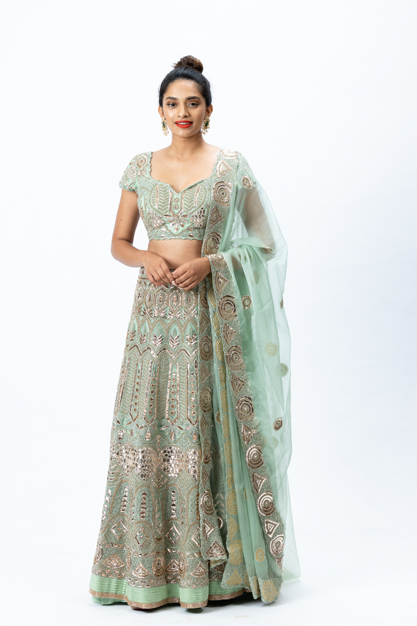 Mint Green Hand-embroidered Lehenga paired with Hand-embroidered Blouse, Hand-embroidered Dupatta and Hand-embroidered Long Jacket with Buttis