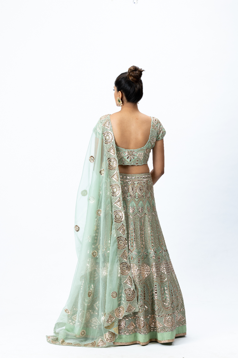 Mint Green Hand-embroidered Lehenga paired with Hand-embroidered Blouse, Hand-embroidered Dupatta and Hand-embroidered Long Jacket with Buttis