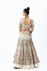 Beige Hand-embroidered Lehenga paired with Puff-sleeved Hand-embroidered Blouse and Hand-embroidered Dupatta with buttis